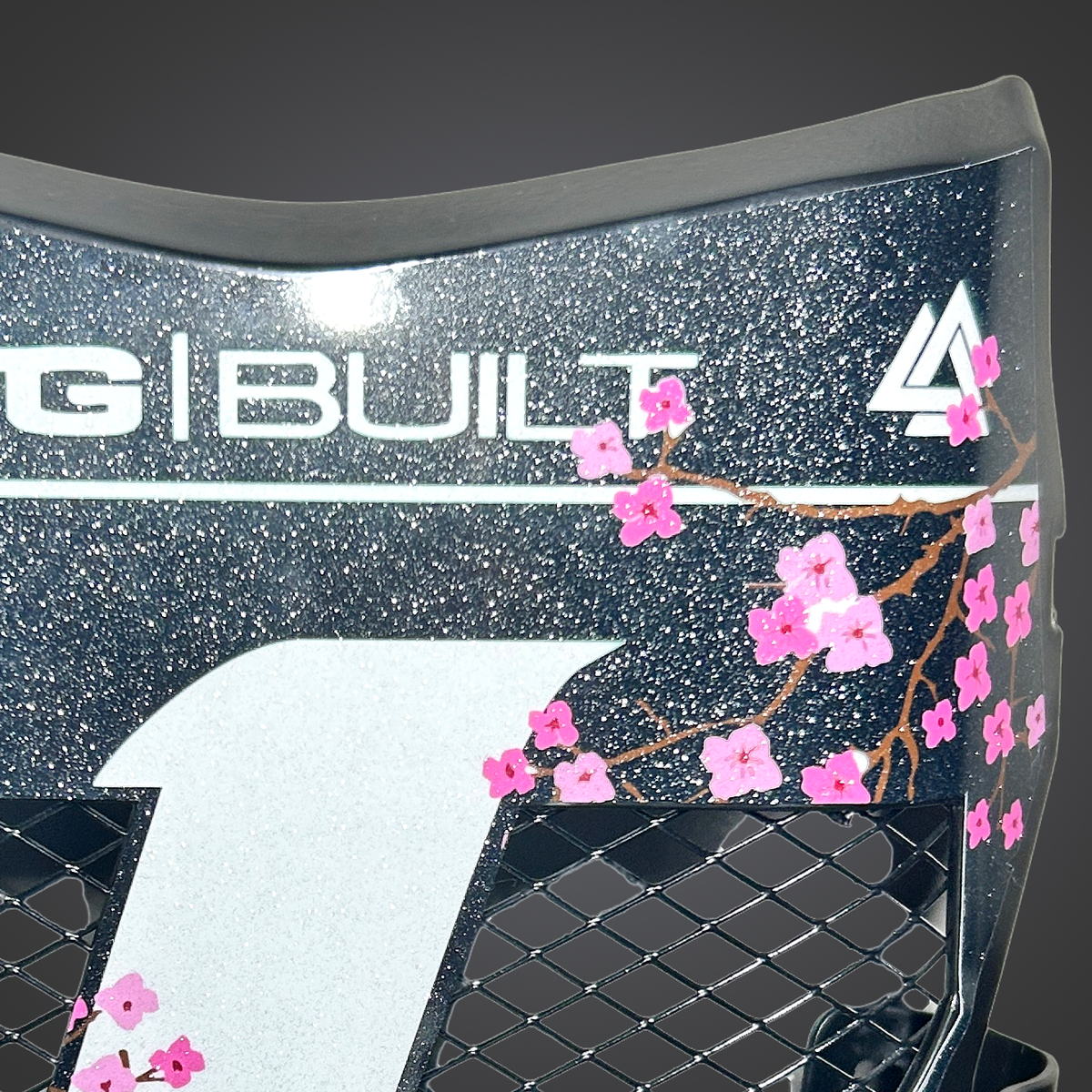 Close-up of the cherry blossom artwork and sparkle finish on the white vinyl vented plate